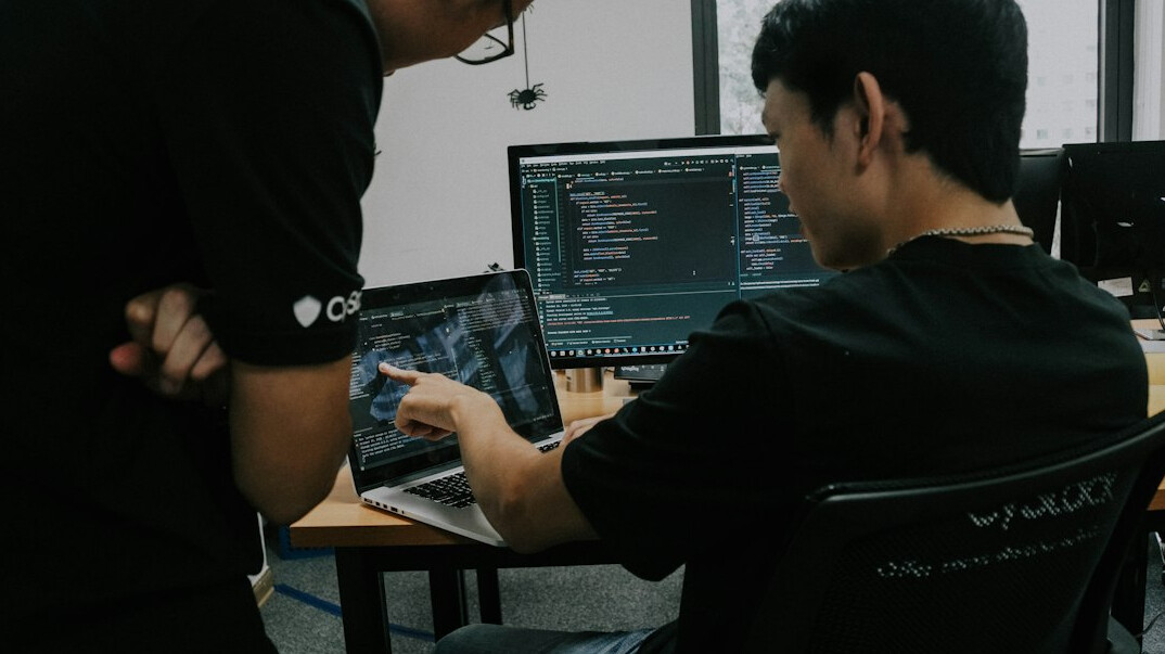 programmer coding on laptop