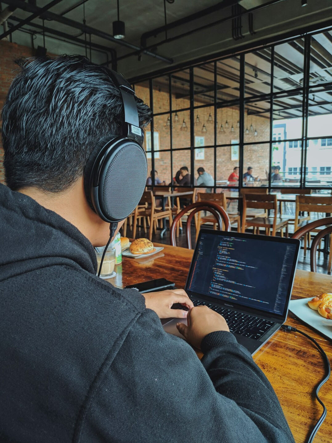 young man coding on laptop